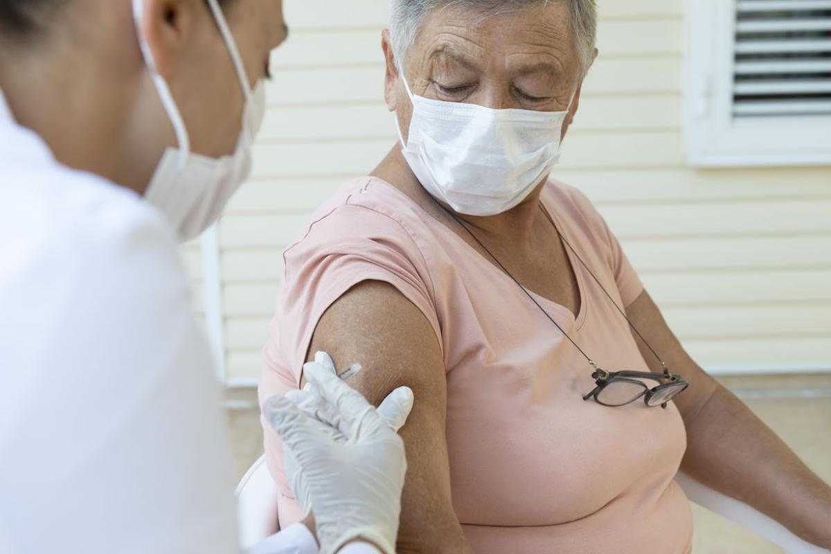 Person receiving a vaccine.