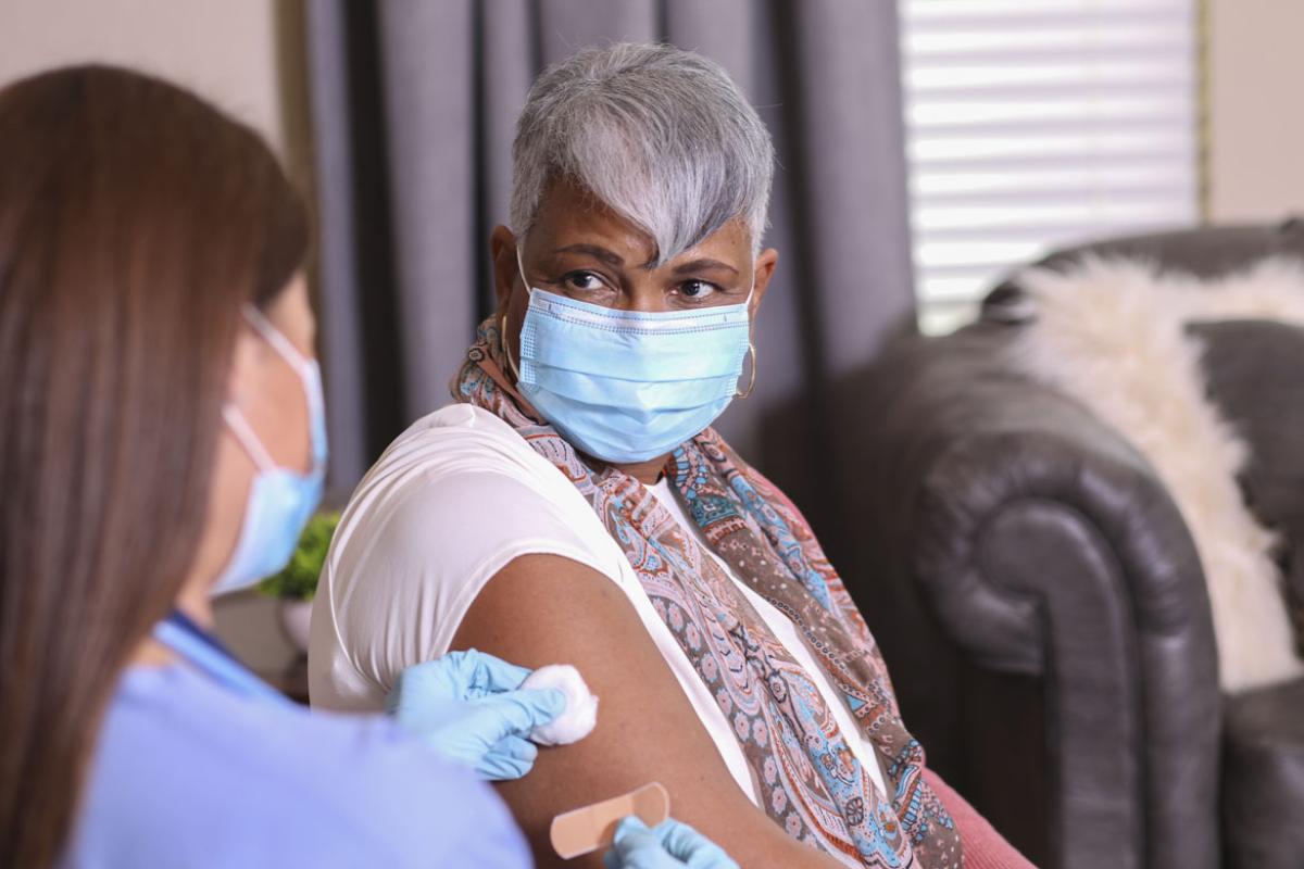 Health care worker and patient after patient receives injection