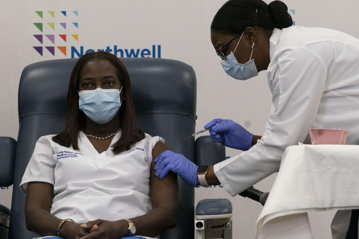 A physician giving a patient a vaccination.