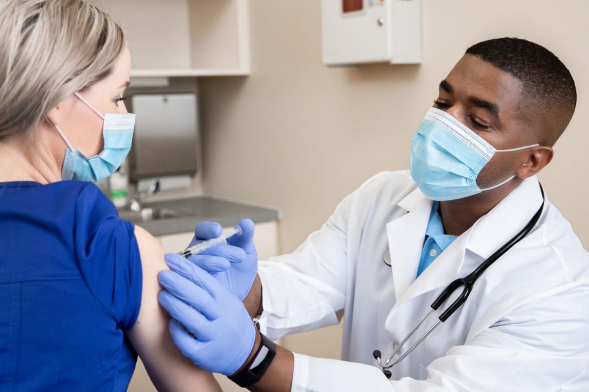 Physician administering a vaccine