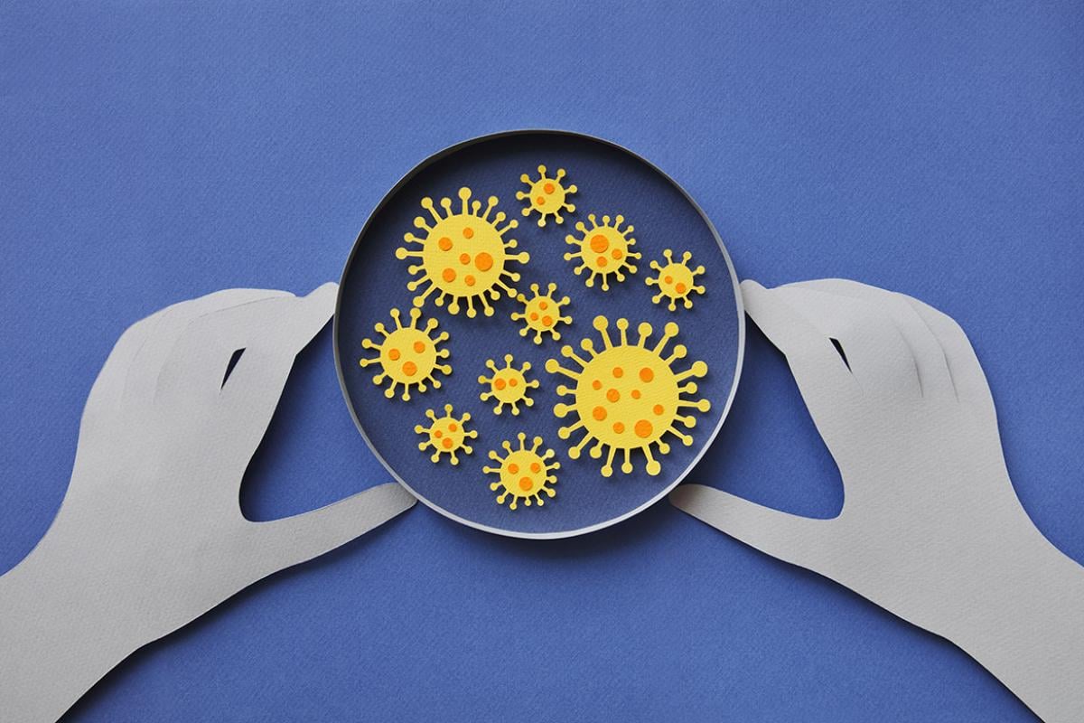 Illustration of human hands and coronavirus in a lab