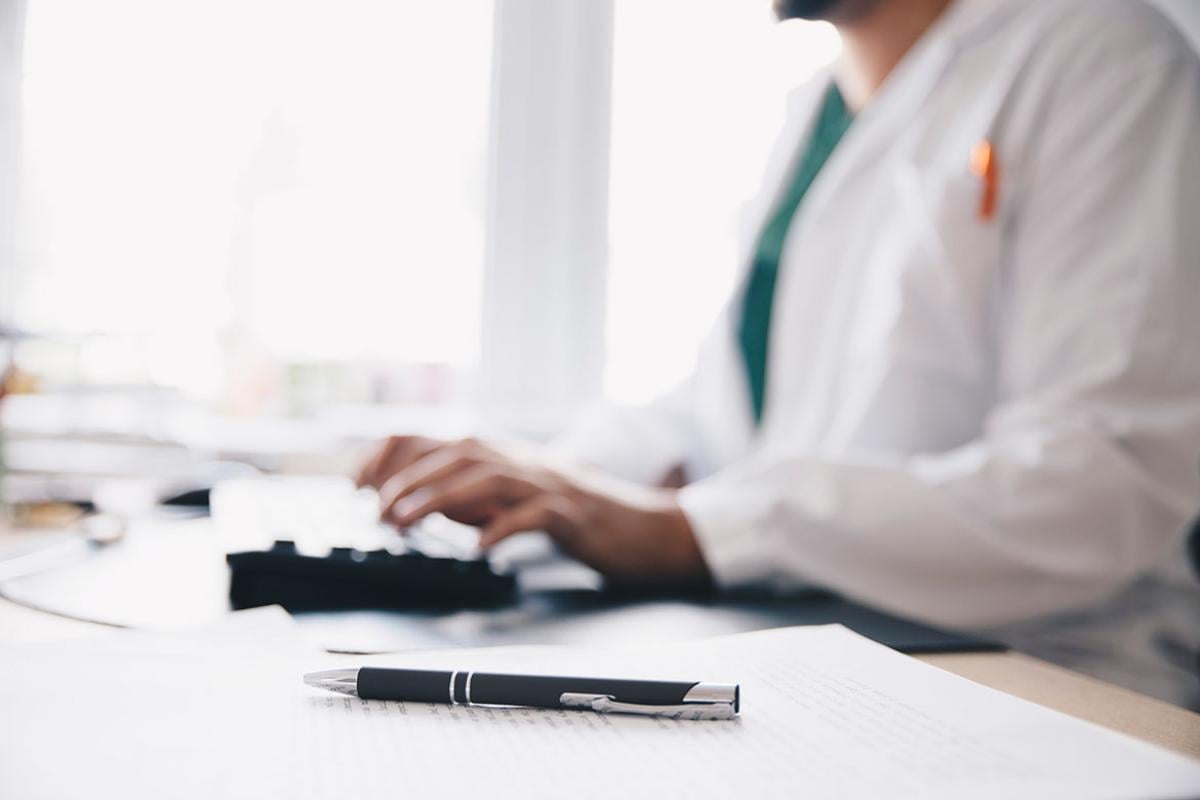 Physician working at computer