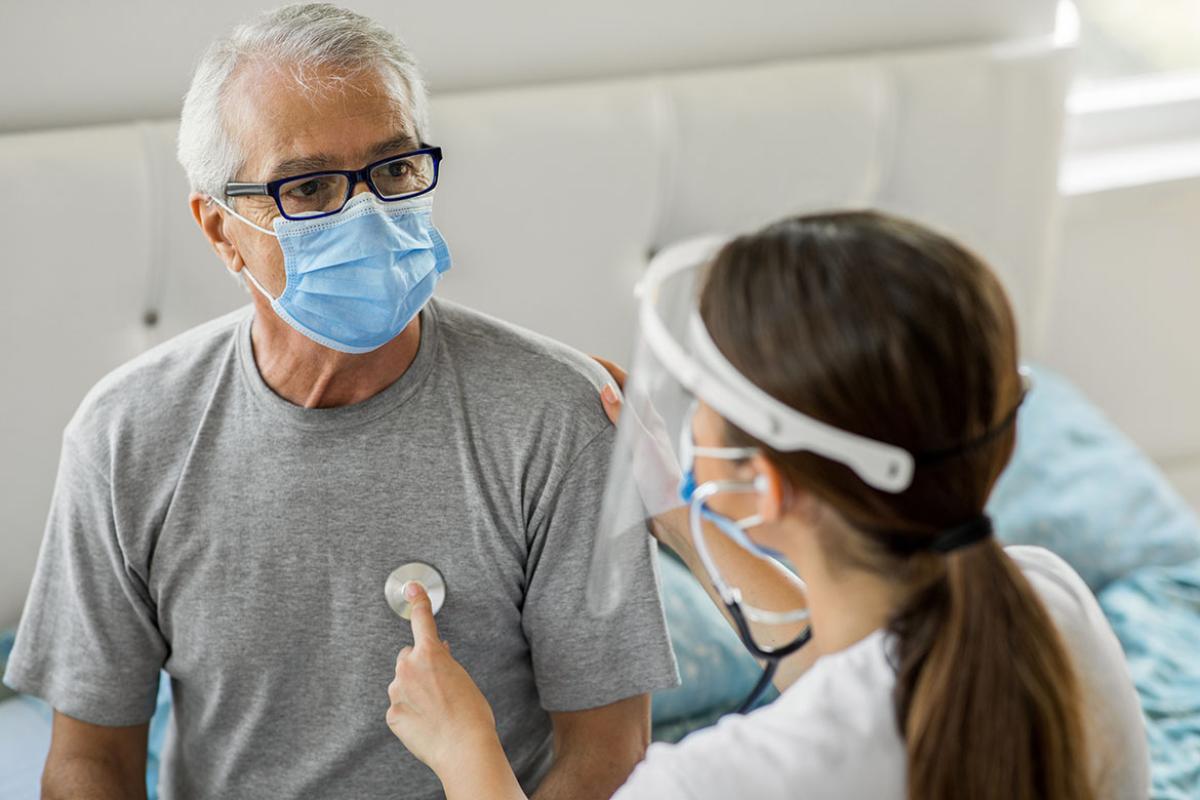 Health visitor and a senior person during home visit