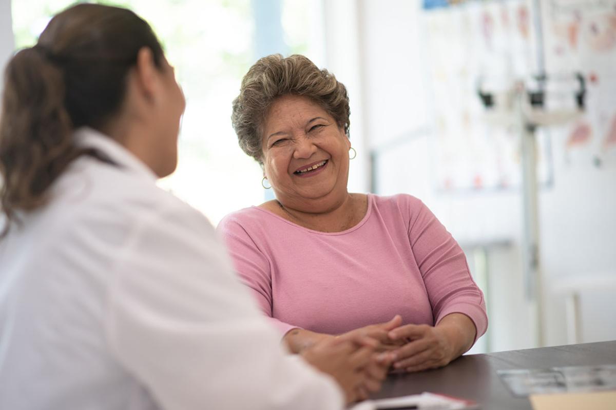 Smiling patient in conversation with health care worker