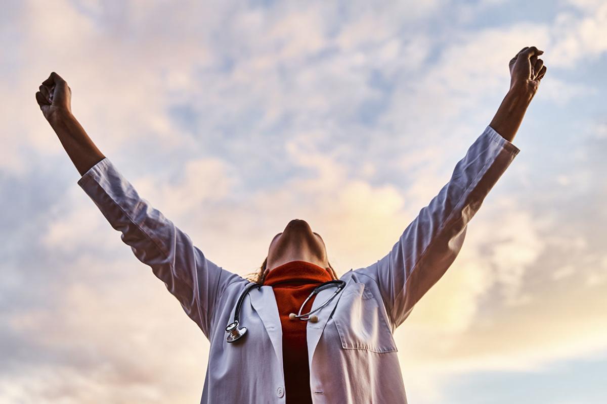 Physician with arms raised to the sky