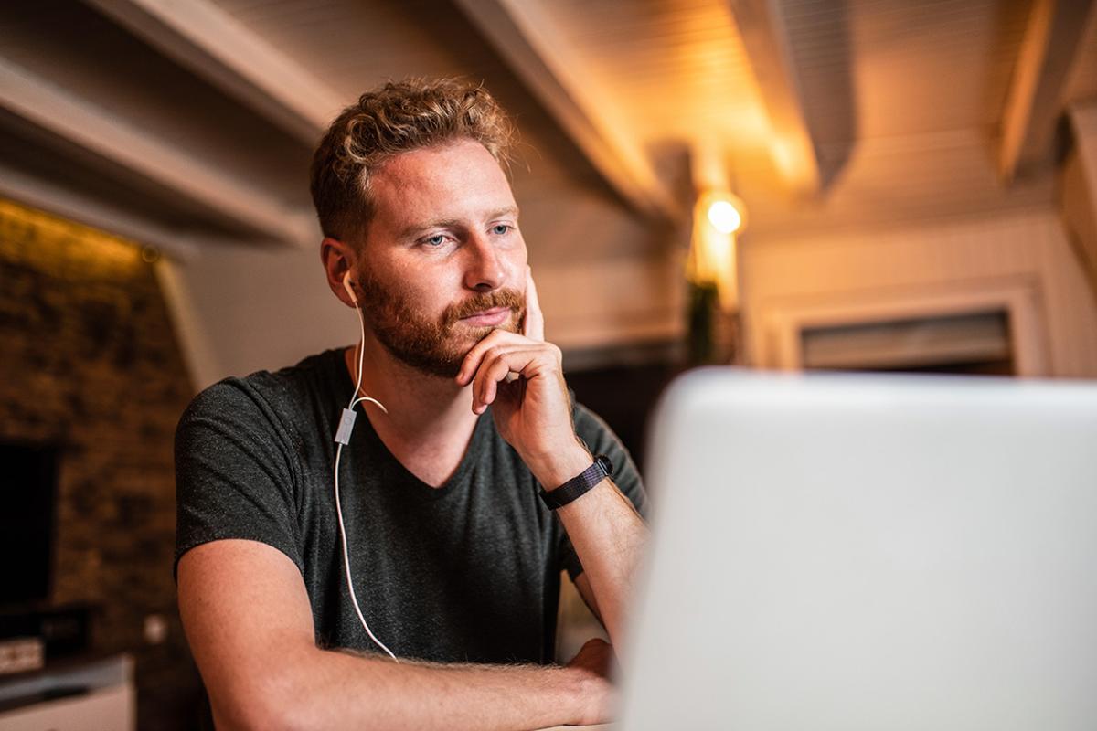 Young man looking at laptop at home