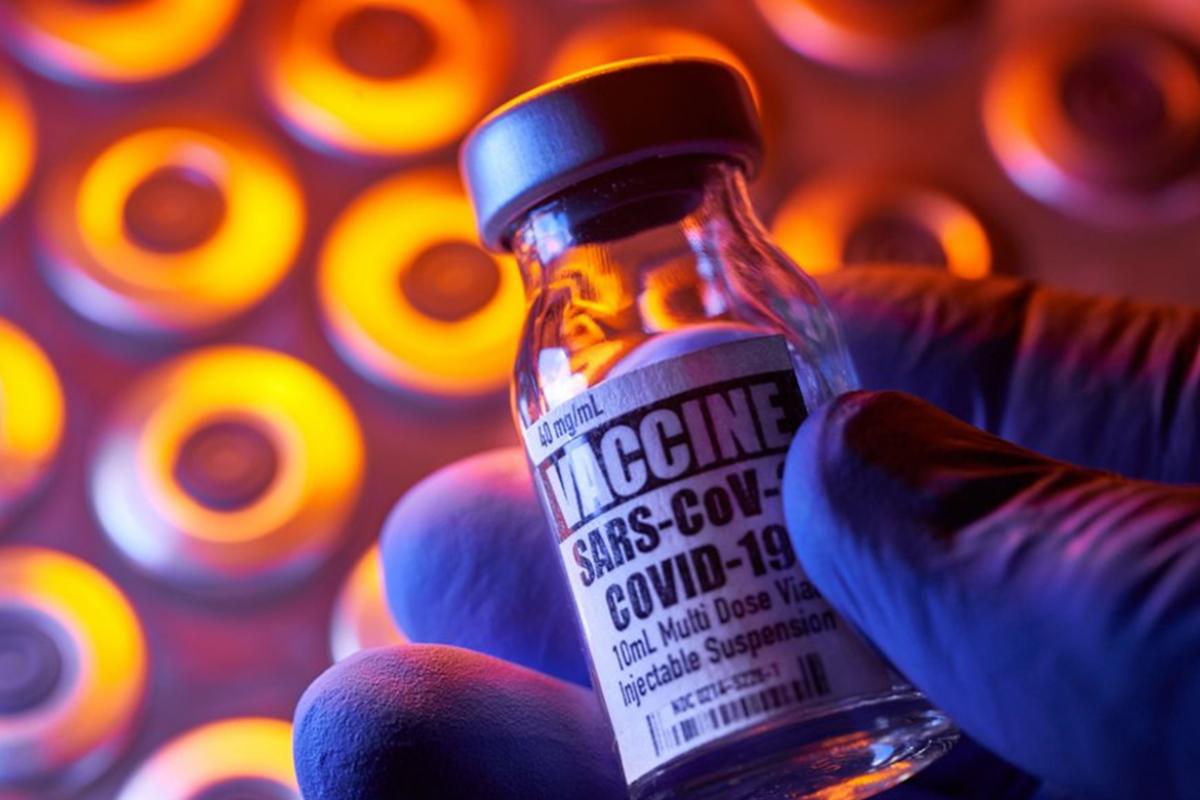 Vaccine bottle against a backdrop of vials